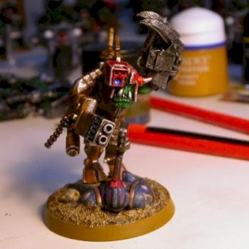 Ork meganob in a stealth suit, standing on a Space Marine corpse. by aca121